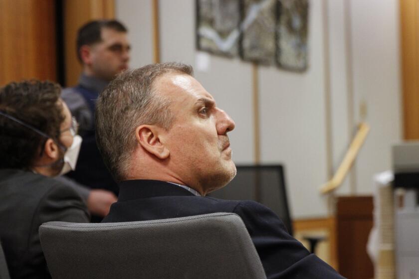 FILE - Brian Steven Smith watches proceedings during the opening day of his double murder trial, Tuesday, Feb. 6, 2024, in Anchorage, Alaska. Federal prosecutors want to revoke the U.S. citizenship of Smith, a South Africa man convicted of killing two Alaska Native women for allegedly lying on his naturalization application for saying he had neither killed nor hurt anyone. (AP Photo/Mark Thiessen, File)