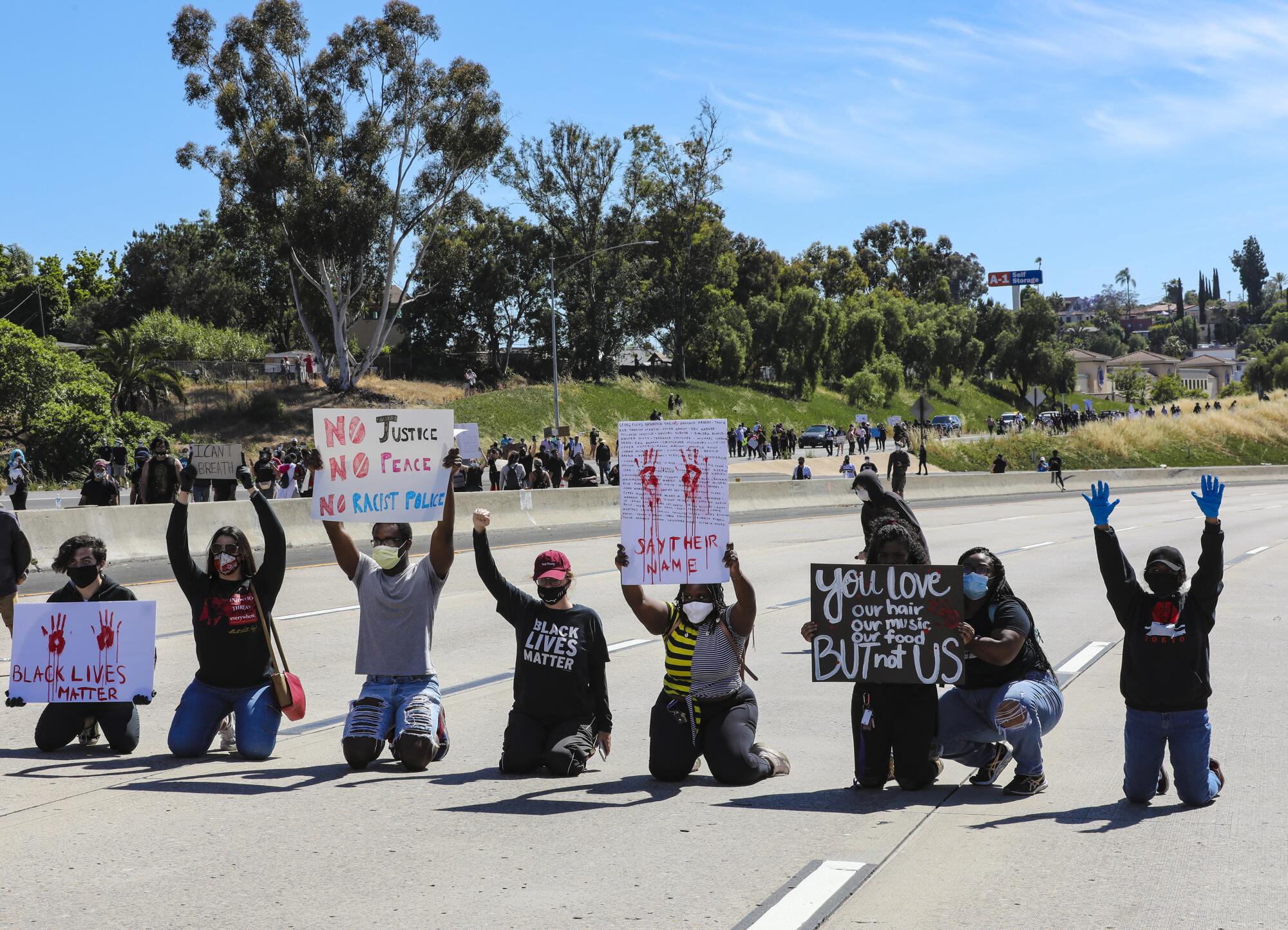 Protestors in support of calling for justice for George Floyd temporary blocked the westbound freeway lanes on Interstate 8 during a protest in La Mesa on Saturday.