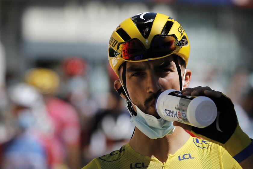 France's Julian Alaphilippe, wearing the overall leader's yellow jersey drinks at the start of the fifth stage of the Tour de France cycling race over 183 kilometers (114 miles), with start in Gap and finish in Privas, Wednesday, Sept. 2, 2020. (AP Photo/Christophe Ena)