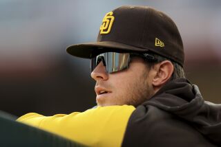 San Diego Padres' Wil Myers watches from the dugout during a baseball game against the Cincinnati Reds in Cincinnati, Wednesday, April 27, 2022. The Padres won 8-5. (AP Photo/Aaron Doster)