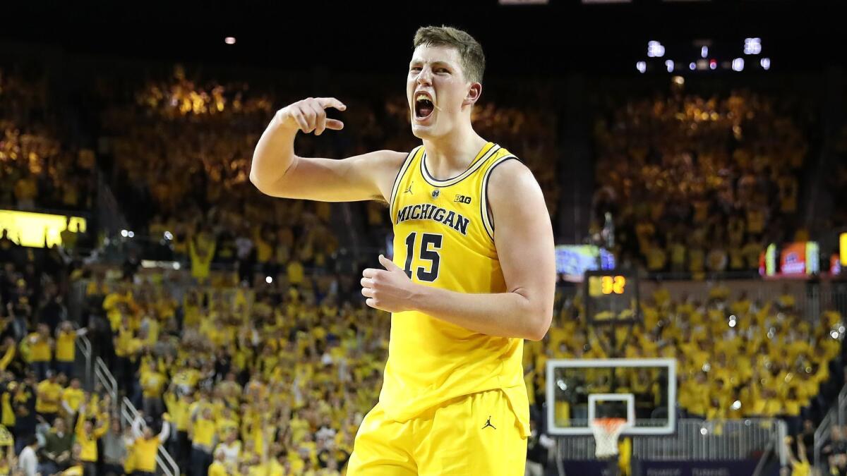 Jon Teske of the Michigan Wolverines celebrates a three pointer in the first half.