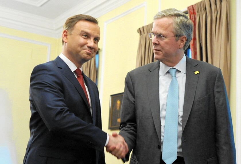 Jeb Bush, right, meets with Polish President-elect Andrzej Duda in Warsaw.
