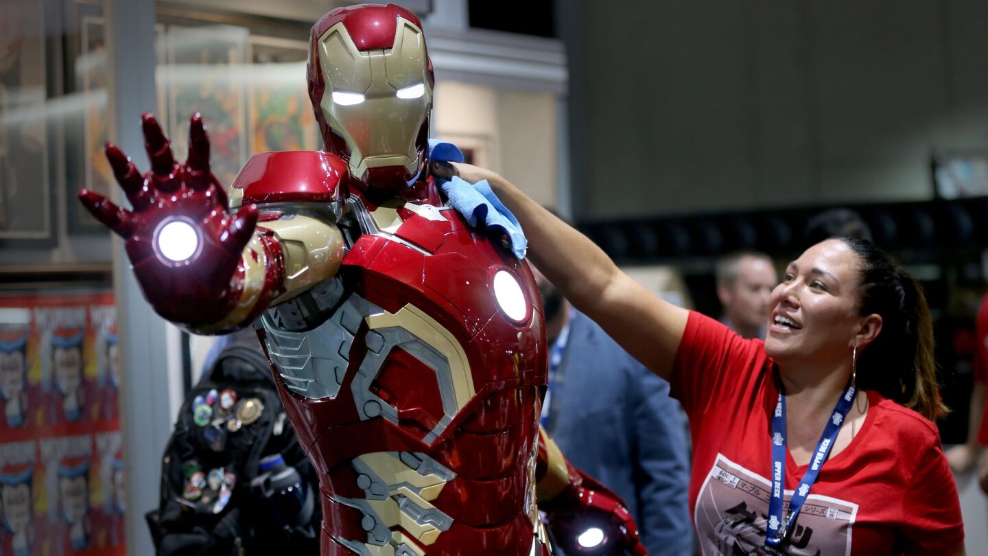 Bree Klusmeyer polishes Tony Stark at the Upper Deck Gallery booth at Comic-Con International.