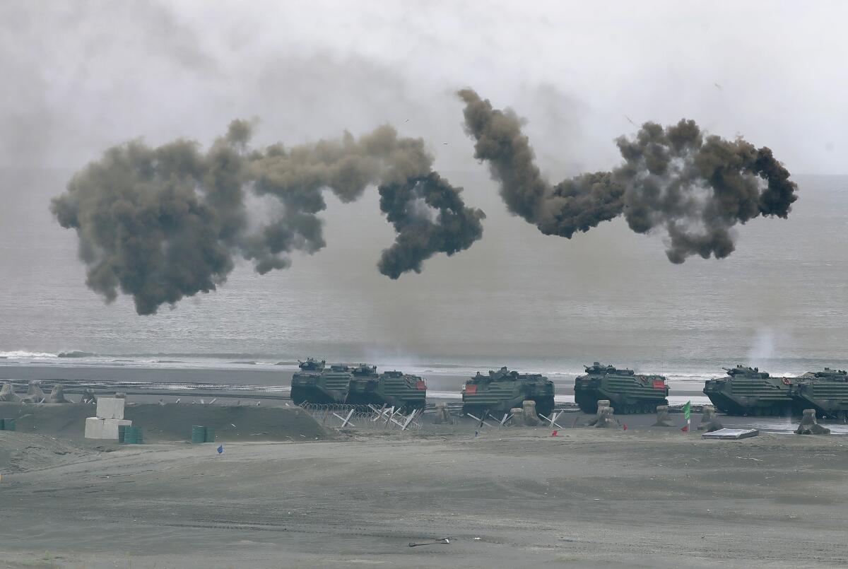 Smoke hangs in the air above military vehicles