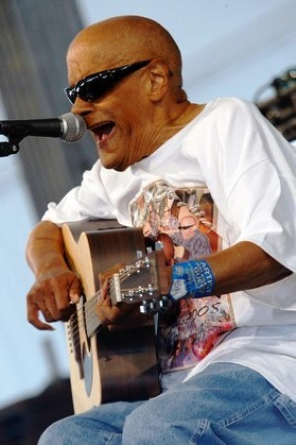 Musician Snooks Eaglin, here performing at last year's New Orleans Jazz and Heritage Festival, had an unusual playing style: He'd pick guitar strings with his thumbnail.