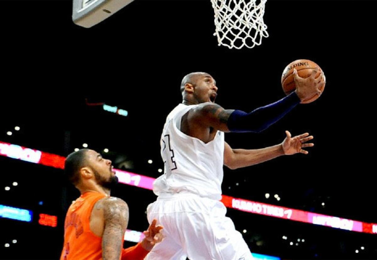 Kobe Bryant drives in for a reverse layup against the Knicks' Tyson Chandler.