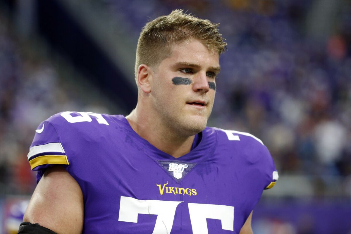 FILE - In this Sept. 8, 2019, file photo, Minnesota Vikings offensive tackle Brian O'Neill walks on the field before an NFL football game against the Atlanta Falcons in Minneapolis. The Vikings have signed O’Neill to a contract extension. (AP Photo/Bruce Kluckhohn, File)