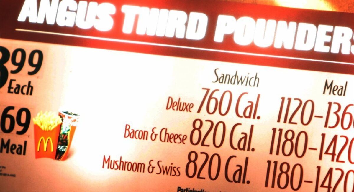 One example of a policy "nudge" -- an effort to get people to make choices that benefit themselves without using coercion -- is requiring chain restaurants to post calorie counts on their menus. Above, a McDonald's restaurant in New York City lists calorie counts.