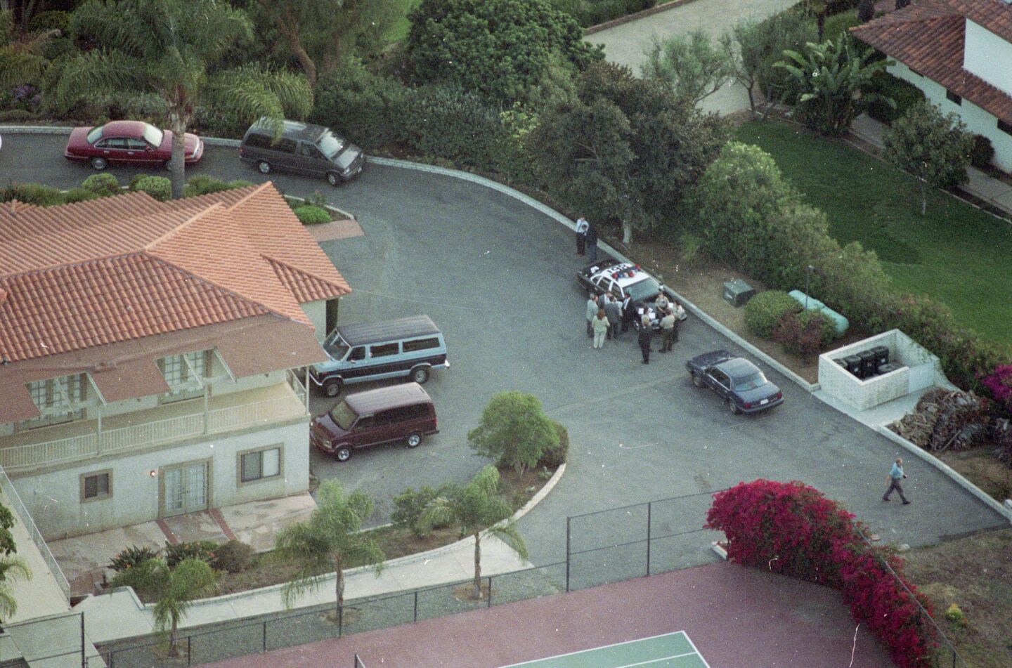 Investigators gather outside the Rancho Santa Fe mansion 39 bodies of Heaven's Gate members were found on March 26, 1997. They died in a mass suicide.