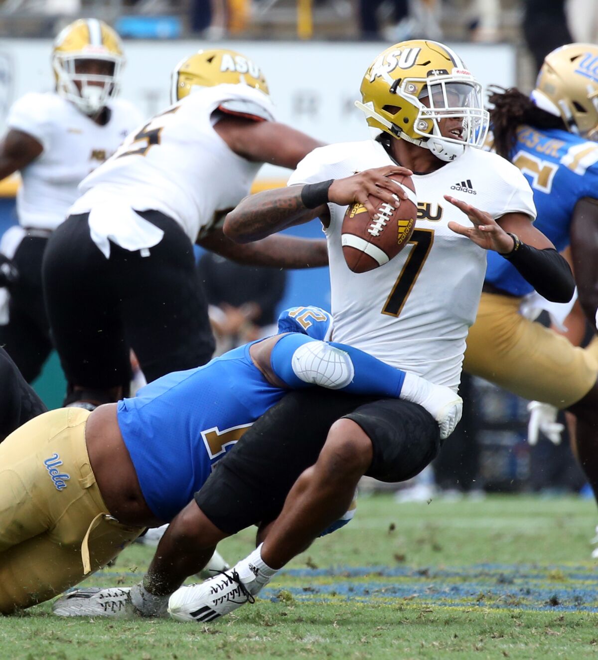 UCLA defensive lineman Grayson Murphy sacks Alabama State quarterback Myles Crawley in the second quarter.