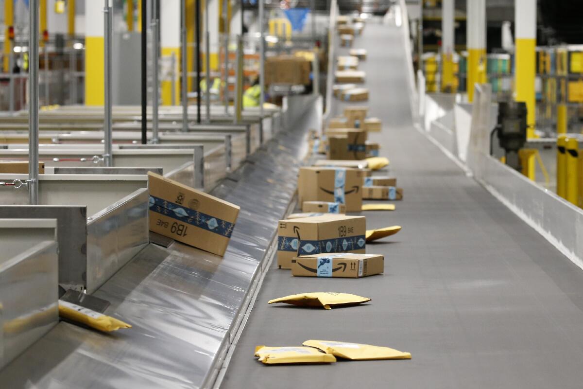 Packages move along a conveyor.