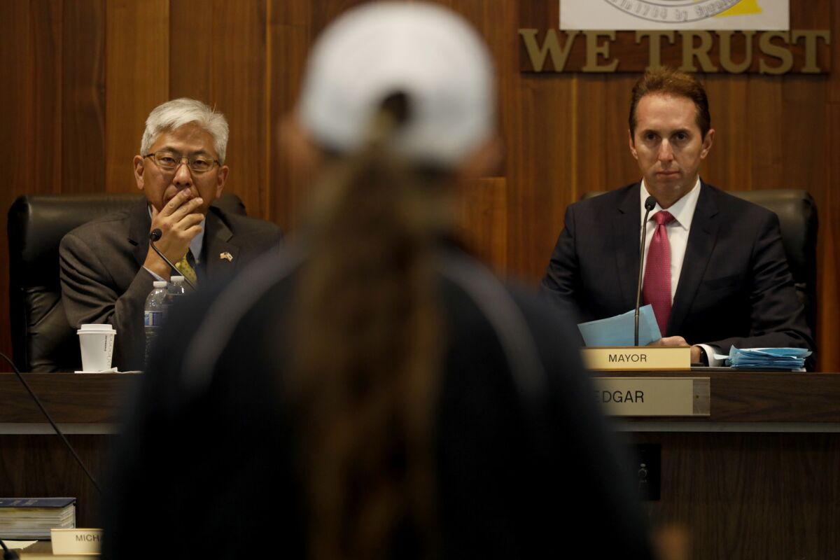 Los Alamitos Mayor Pro Tem Warren Kusumoto, left, and Mayor Troy Edgar listen to public comment on a proposed "sanctuary ordinance" in the city.