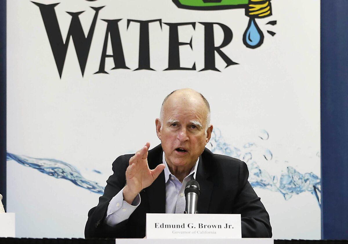 Gov. Jerry Brown talks with reporters in April after a meeting about the drought at his Capitol office in Sacramento.