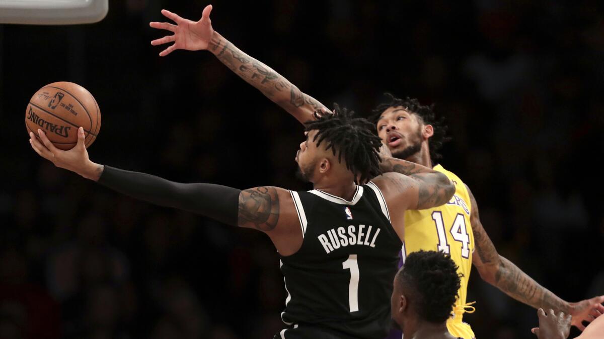 Nets guard D'Angelo Russell,has his layup challenged by Lakers forward Brandon Ingram during the first half of a game Nov. 3.