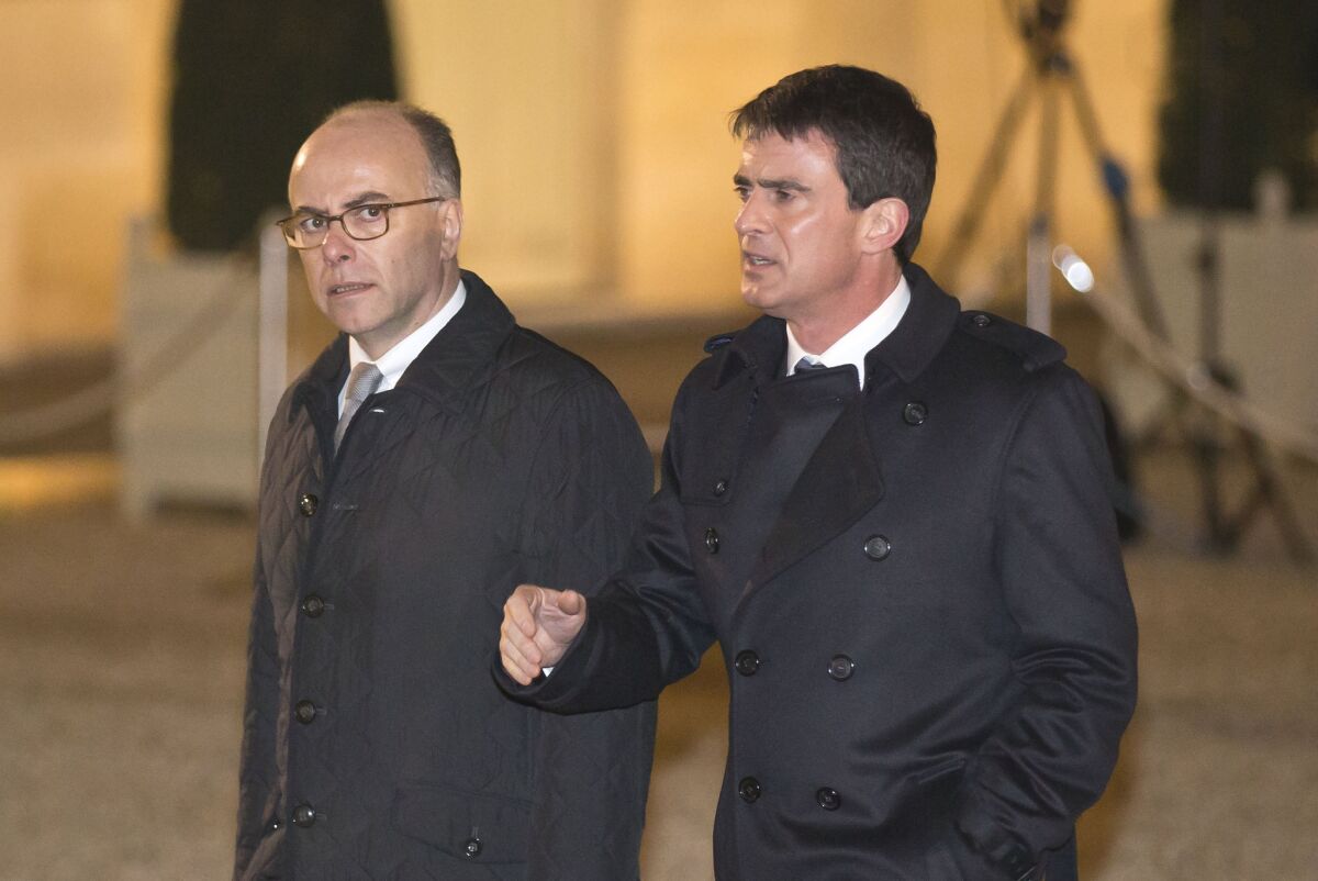 French Interior Minister Bernard Cazeneuve, left, and French Prime Minister Manuel Valls, arrive for a meeting with religious leaders at the Elysee Palace.