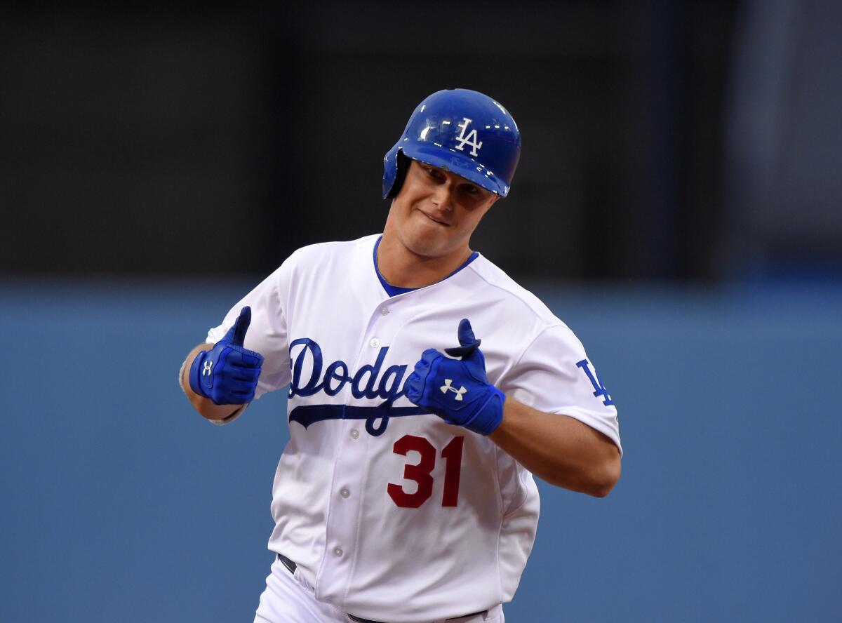 Dodgers outfielder Joc Pederson gives two thumbs up after his solo home run in the first inning Saturday against San Diego.