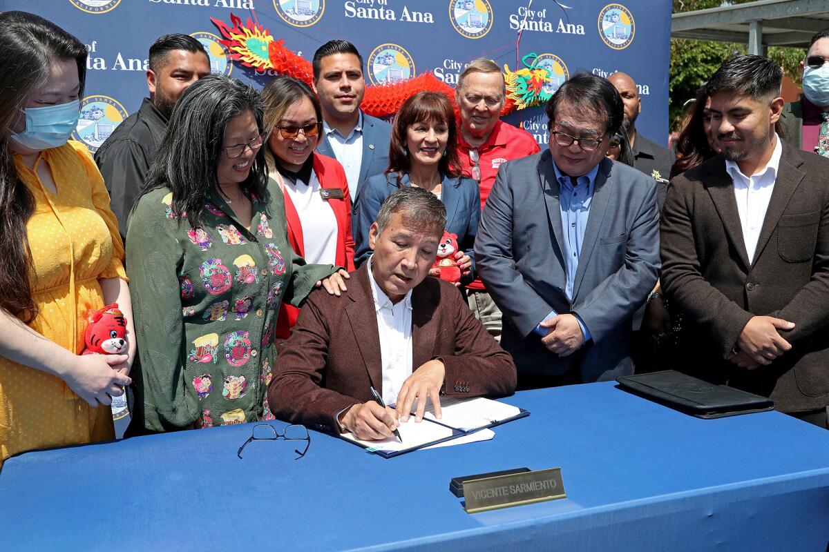 Mayor Vicente Sarmiento signs the Chinatown Apology Resolution.