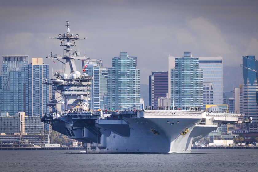 The aircraft carrier USS Theodore Roosevelt, flagship of Carrier Strike Group 9, travels through San Diego Bay as seen from Shelter Island after leaving Naval Air Station North Island, starting a scheduled deployment to the U.S. Indo-Pacific Command region, January 17, 2020 in San Diego, California.