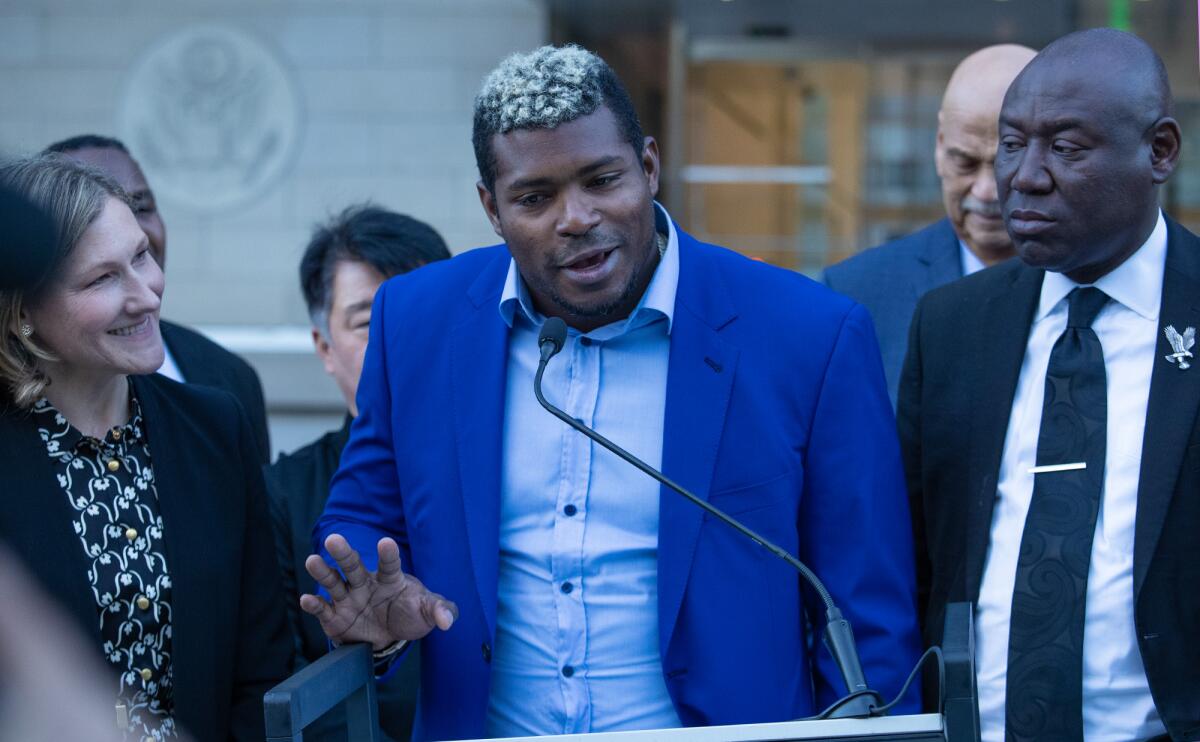 Former Dodgers outfielder Yasiel Puig speaks at a news conference outside the federal courthouse.