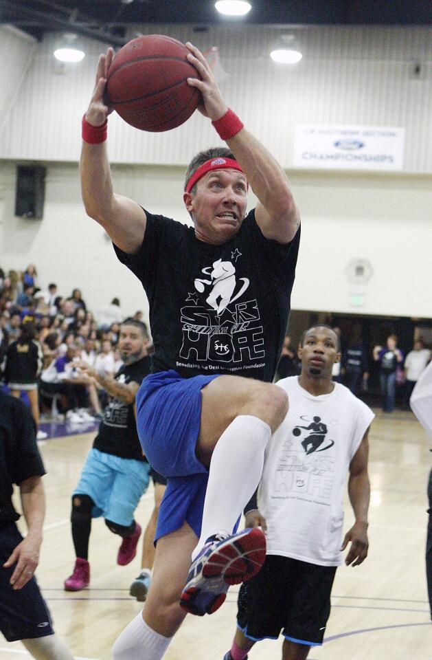 Hoover High's Kevin Witt drives to the basket for the teachers against the celebrities at the Stars Shooting for Hope celebrity basketball game at Hoover High School on Friday, March 7, 2014. The game, which has been played for 6 years, has raised over $10,000 for the Desi Geetsman Foundation. The teachers won the game.