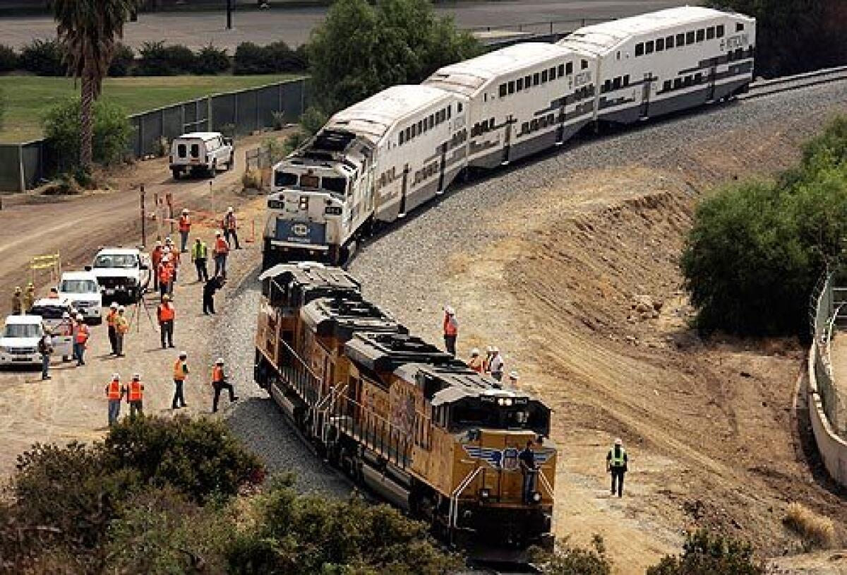 A Metrolink train and a freight train are used to reenact Friday's deadly collision. Investigators with the National Transportation Safety Board were doing a "sight distance survey" to determine at what point the engineers on the ill-fated trains first saw each other. More photos >>>