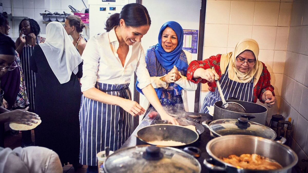 After the Grenfell Tower fire, Meghan Markle participates in the cooking at the Hubb Community Kitchen at the Al Manaar Muslim Cultural Heritage Centre in West London.