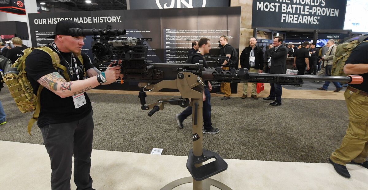 Kenneth Conkright of Colorado looks at a .50-caliber M2 machine gun at a 2018 trade show in Las Vegas.