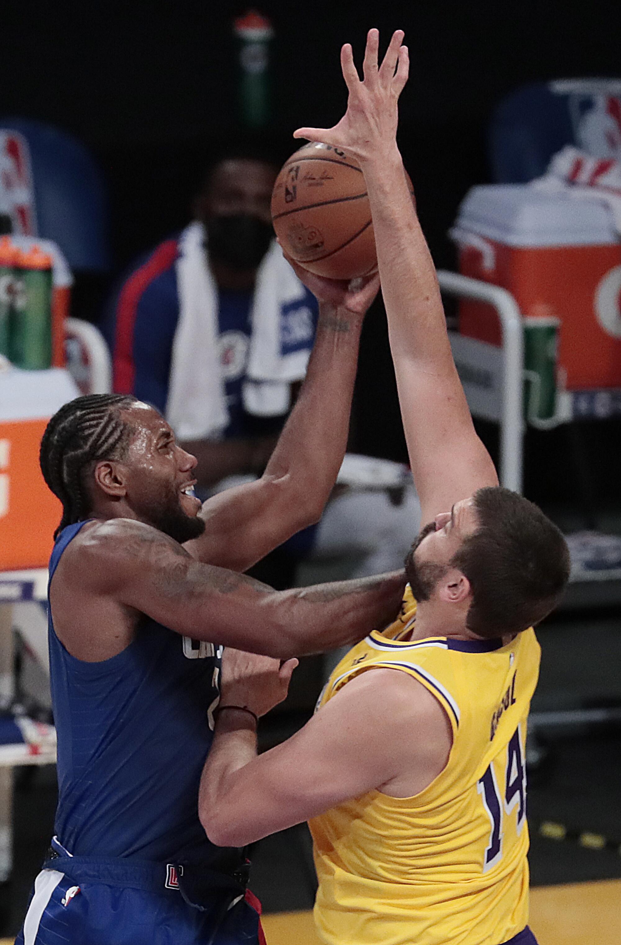 Lakers center Marc Gasol (14) challenges the shot of Clippers forward Kawhi Leonard during the first half.