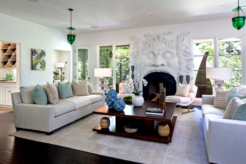 Geena Davis' Pacific Palisades home opens to a living room with a sculptural fireplace.