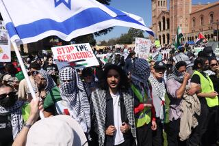 Los Angeles, CA - April 28:Pro-Israeli and Palestinian demonstrators clashed in a large and noisy demonstration at UCLA on Sunday, shouting slogans and pulling at police barricades not far from where pro-Palestinian students have maintained a tent encampment for days. (Dania Maxwell / Los Angeles Times)