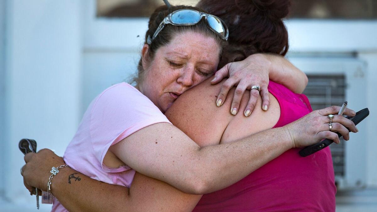 Two women embrace after a fatal shooting at the First Baptist Church in Sutherland Springs, Texas, on Nov. 5.