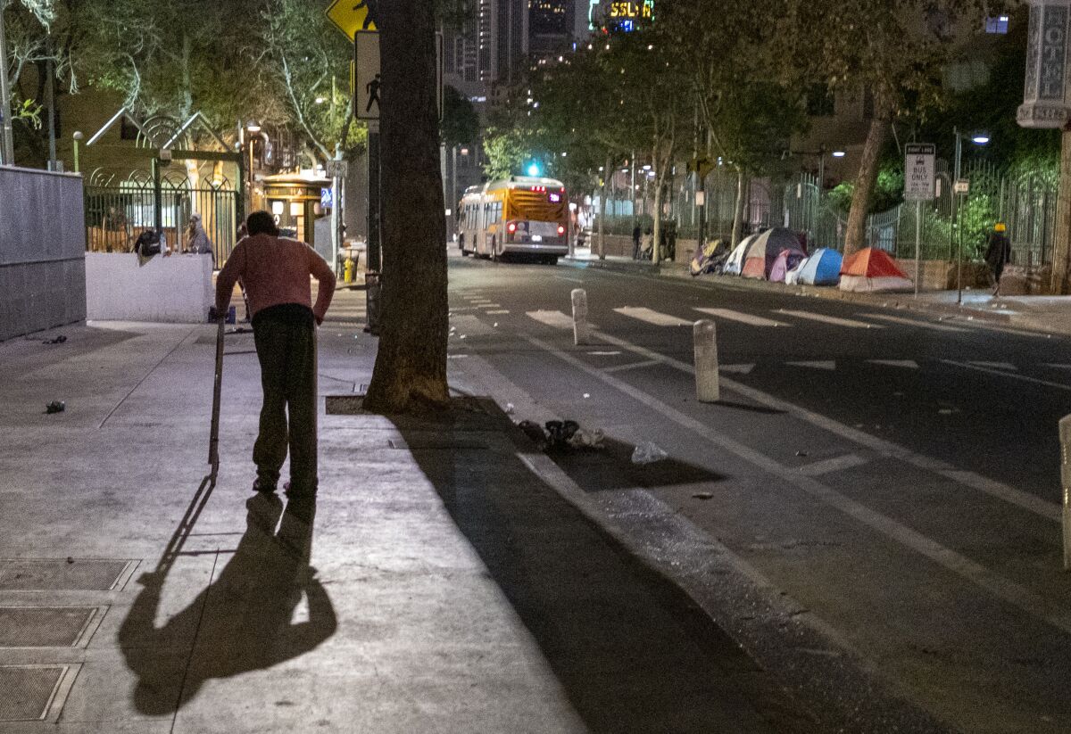 A man pushes his walker in Los Angeles' skid row.