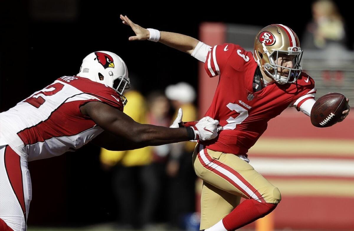 San Francisco quarterback C.J. Beathard runs from Arizona defensive tackle Olsen Pierre during the first half of a game on Nov. 5.