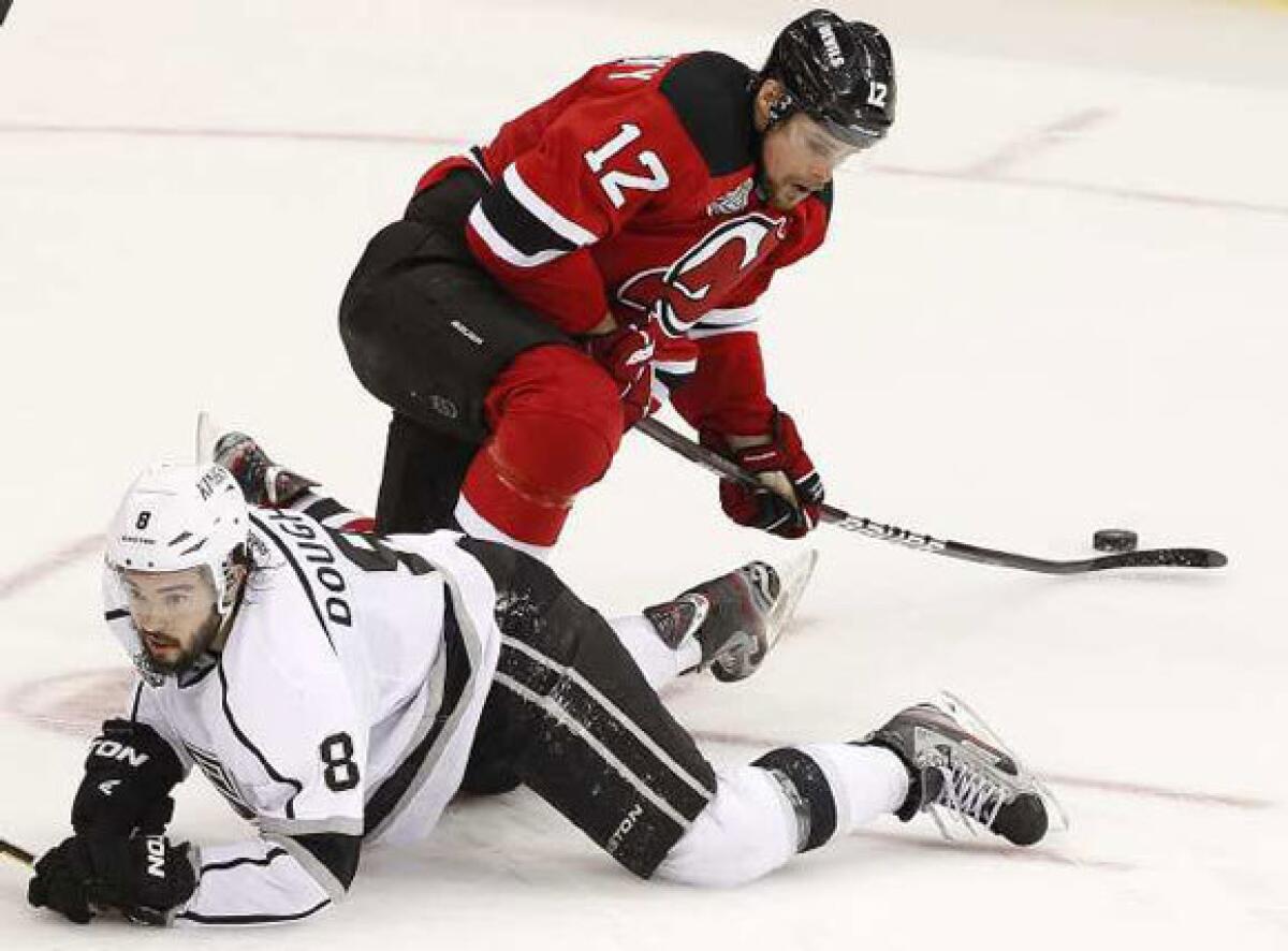 Drew Doughty looks for the puck as Devils winger Alexei Ponikarovsky gathers it in during the third period of Game 5.