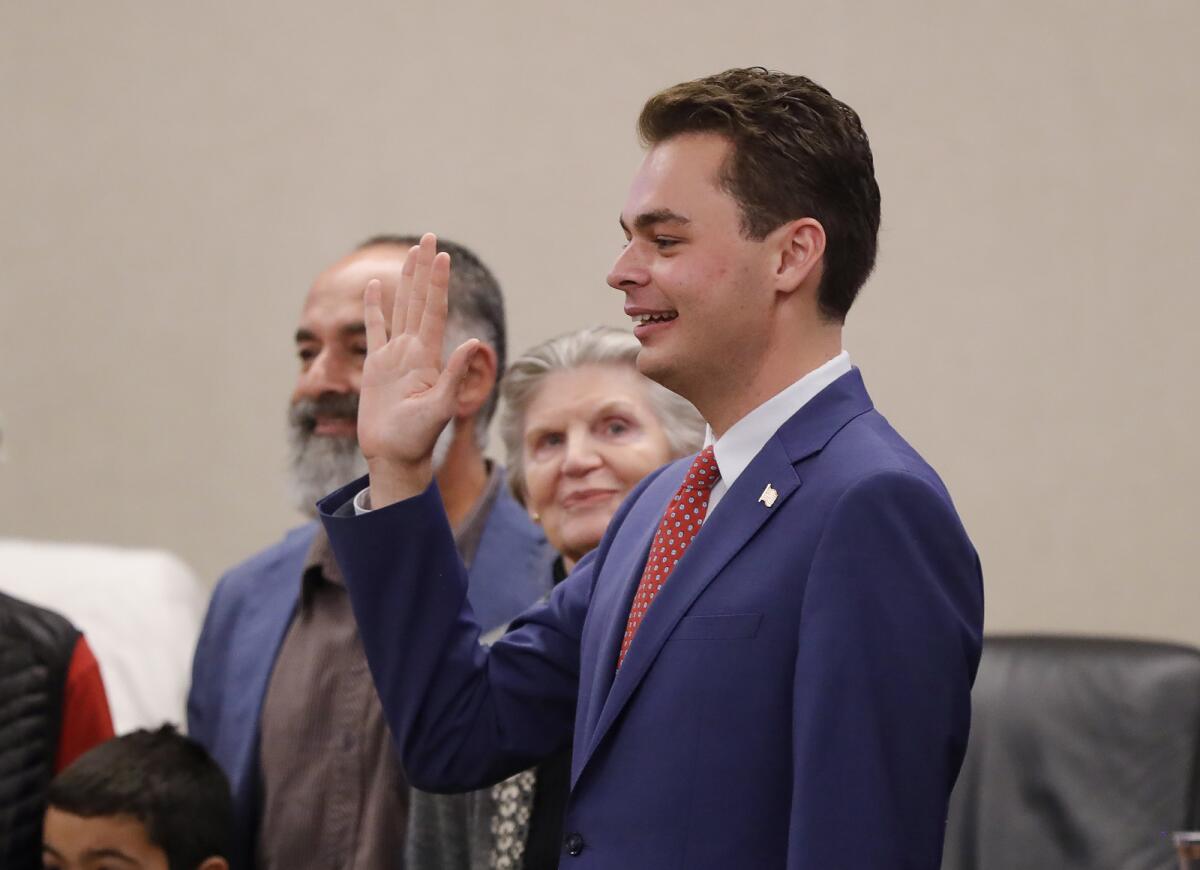 Alex Rounaghi, 25, is sworn in as a member of the Laguna Beach City Council on Tuesday.
