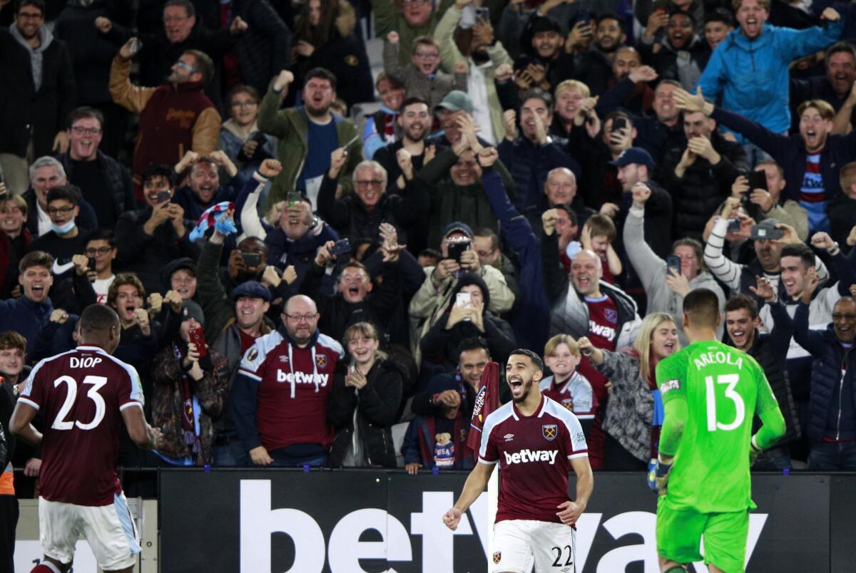 West Ham's Said Benrahma, center, celebrates after scores the winning penalty in a penalty shootout at the end of the English League Cup fourth round soccer match between West Ham United and Manchester City, at the London Stadium, in London, Wednesday, Oct. 27, 2021. (AP Photo/Ian Walton)