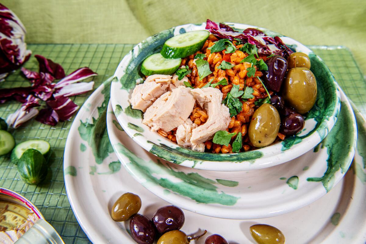 bowl of fish with olives and other vegetables 