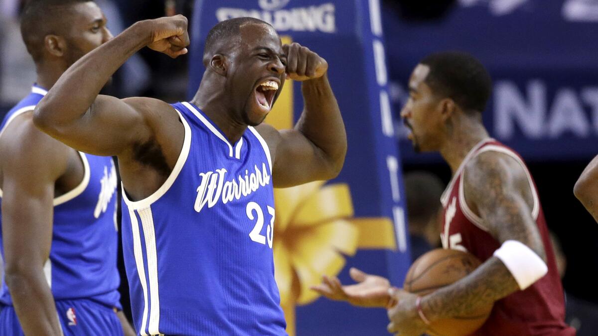 Warriors forward Draymond Green celebrates after scoring against the CCavaliers during the first half Friday.