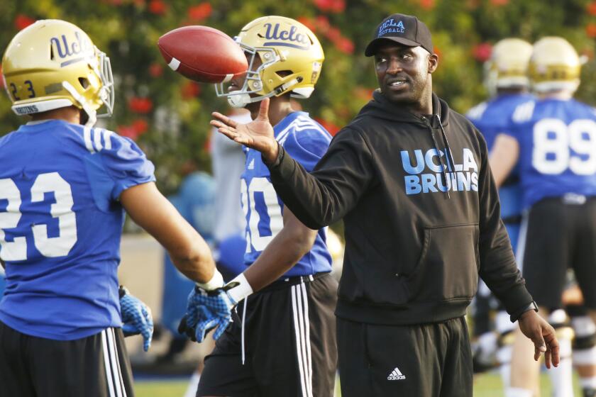 LOS ANGELES, CA - APRIL 6, 2017- UCLA football DeShaun Foster works with running backs.