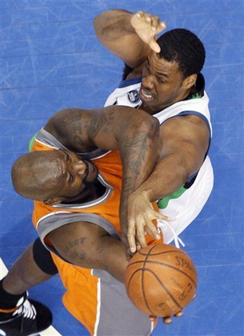 Phoenix Suns center Shaquille O'Neal, left, goes to the basket against Minnesota Timberwolves center Jason Collins, right, during the first quarter of an NBA basketball game in Minneapolis, Saturday, April 11, 2009. (AP Photo/Ann Heisenfelt)