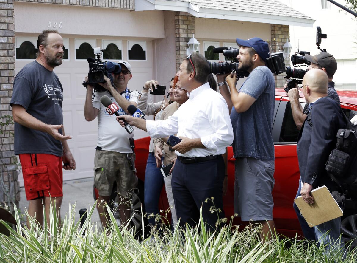 Eric Paddock, left, brother of Las Vegas gunman Stephen Paddock, speaks to members of the media outside his home Monday in Orlando, Fla.