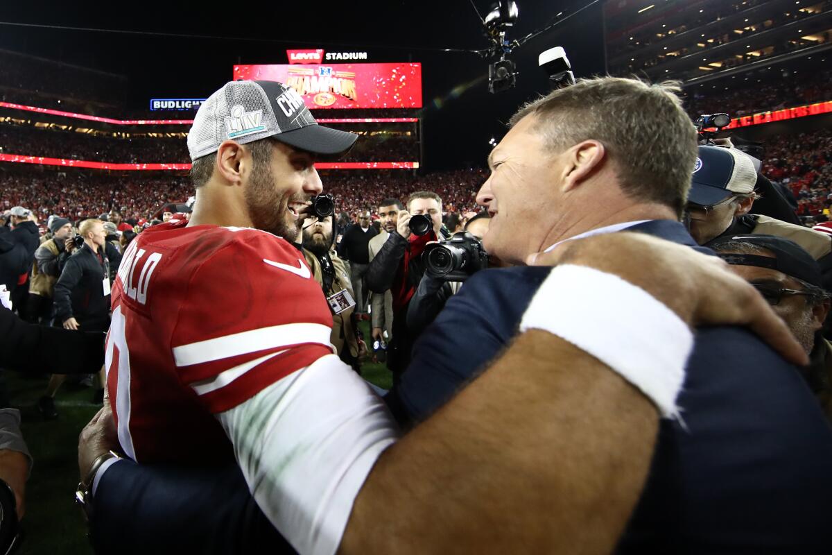 Jimmy Garoppolo of the San Francisco 49ers  hugs general manager John Lynch after winning the NFC Championship game against the Green Bay Packers at Levi's Stadium. 