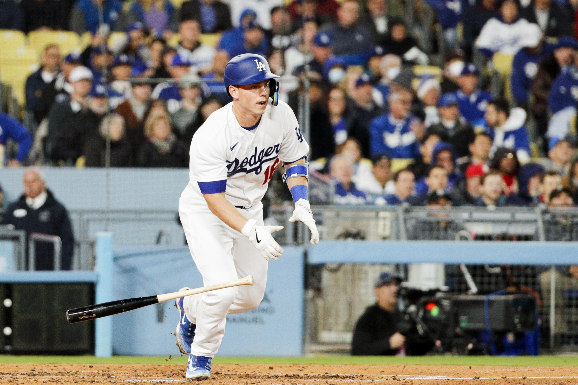 Will Smith tosses his bat after hitting a two-run single during the Dodgers' season-opening win.