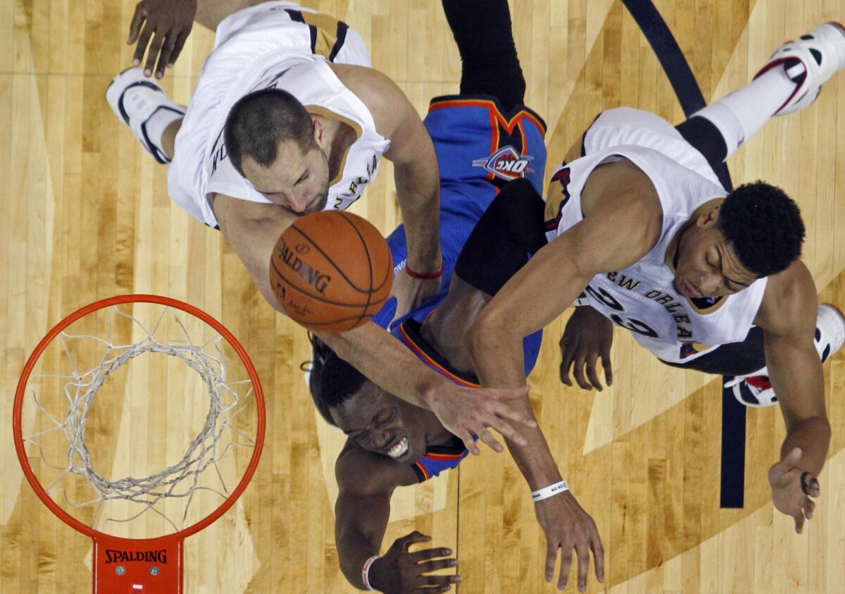 New Orleans' Anthony Davis, right, and Ryan Anderson block a shot by Oklahoma City's Reggie Jackson on Dec. 2.