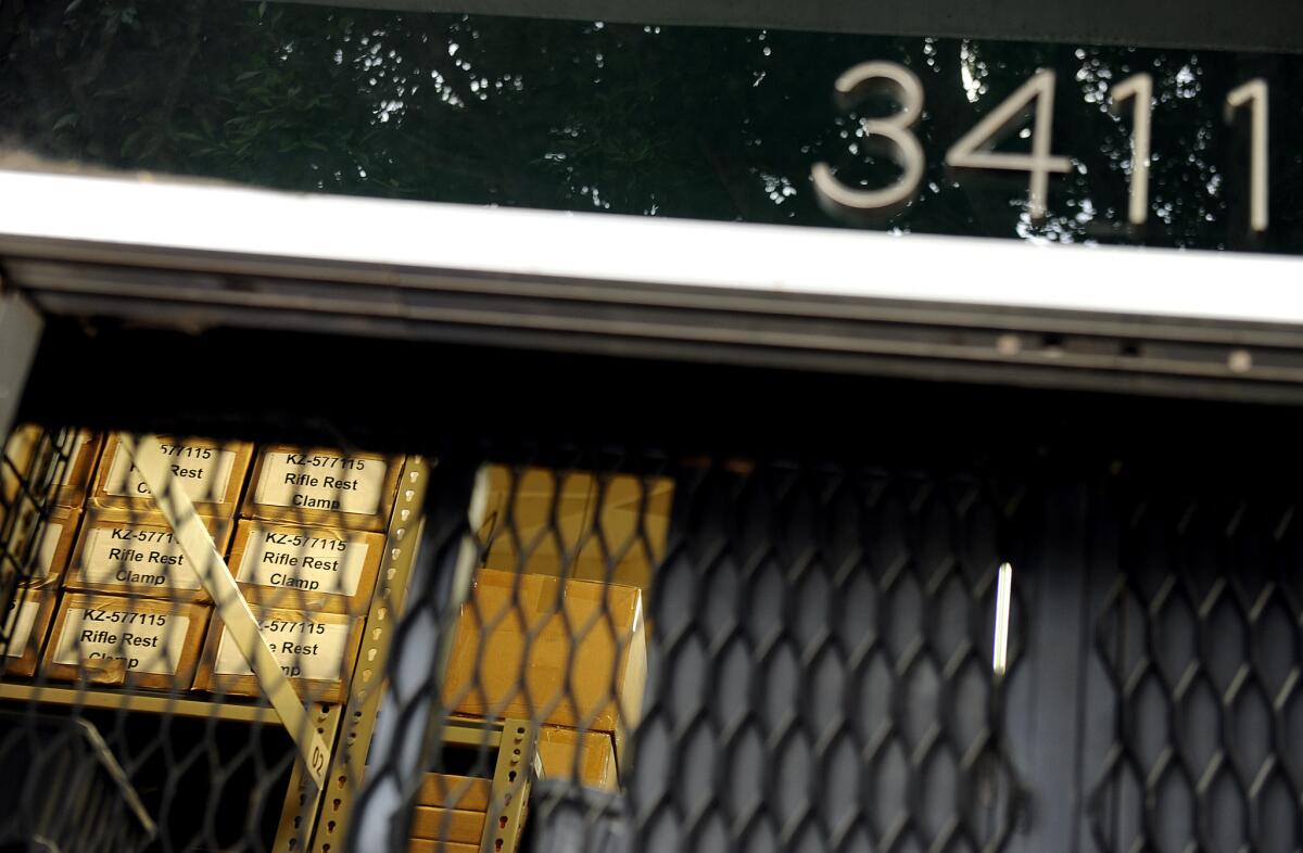 Boxes of supplies can be seen through a grate at one of the Botach Tactical warehouses in Leimert Park in Los Angeles.