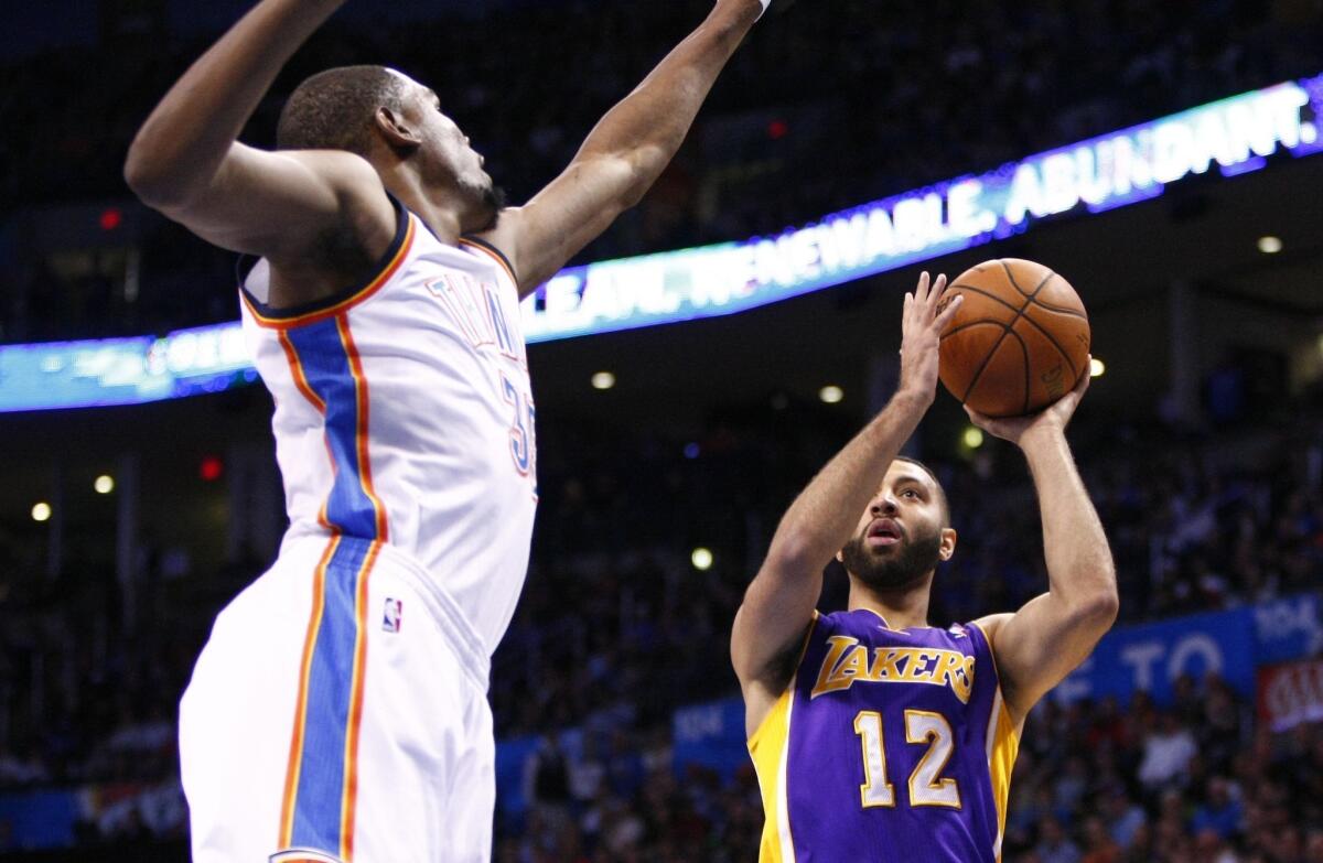 Kendall Marshall gets a shot off in front of the Thunder's Kevin Durant during the first quarter Thursday.