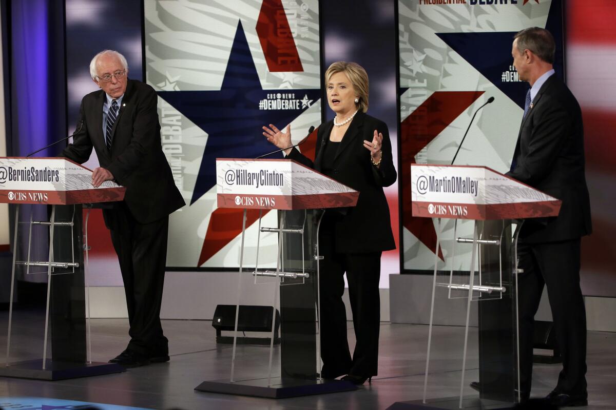 Hillary Rodham Clinton speaks as Bernie Sanders, left, and Martin O'Malley listen during a Democratic presidential primary debate, Saturday, Nov. 14, 2015, in Des Moines, Iowa. (AP Photo/Charlie Neibergall)