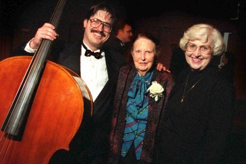 Violin maker Carleen Hutchins, center, is flanked by Joe McNalley and his mother, Sharon, after the inaugural performance by the Hutchins Consort.