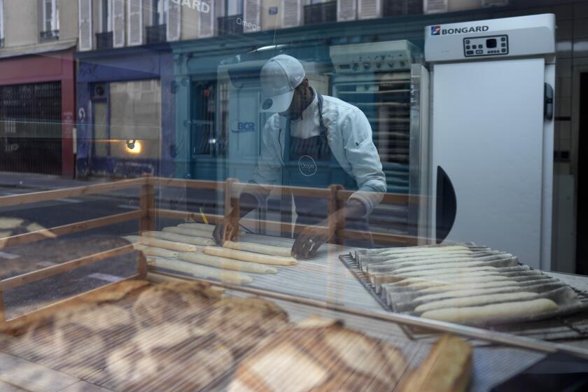 Baker Xavier Netry makes baguettes in the Utopie bakery Friday, April 26, 2024 in Paris. Baker Xavier Netry was chosen this week as the 31st winner of Paris' annual "Grand Prix de la baguette" prize. The Utopie bakery in Paris' 11th district that Netry works for wins 4,000 euros ($4,290) and becomes one of the suppliers of the presidential Elysee Palace for a year. (AP Photo/Thibault Camus)