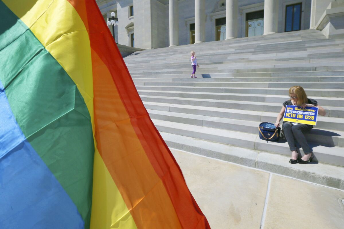 A woman and child arrive at the steps of the Arkansas Capitol in Little Rock on March 30 when lawmakers debated a bill that opponents say allows discrimination against gays and lesbians.